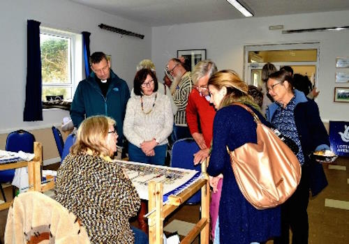 Tapestry stitchers showing off their work